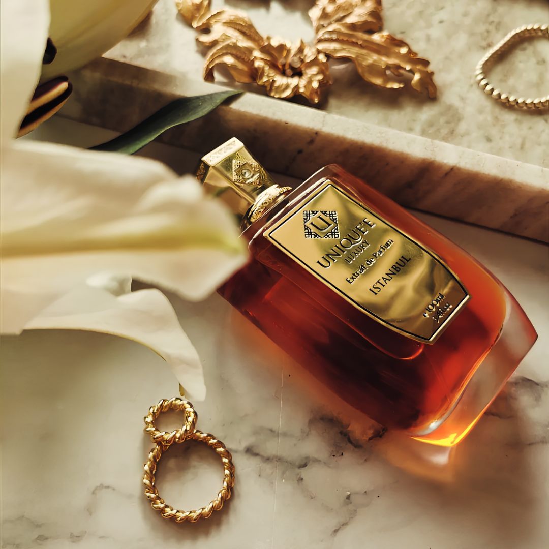 Istanbul Extrait de Parfum 100ml by Unique'e Luxury, elegant glass bottle of EDP fragrance with gold accents and floral design.