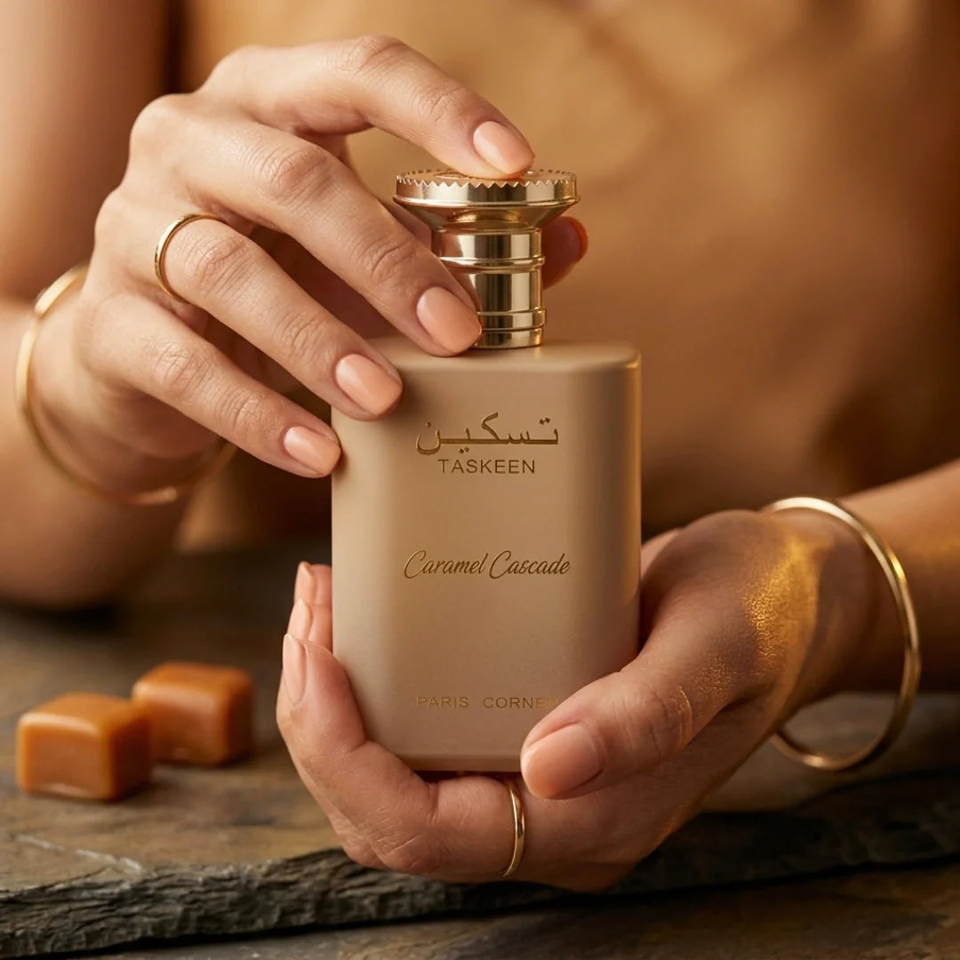 Paris Corner Taskeen Caramel Cascade Eau de Parfum spray 100ml, elegant bottle with caramel-colored liquid inside.